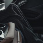 Inclusive Leader - Person Seated At The Back Seat Using Macbook