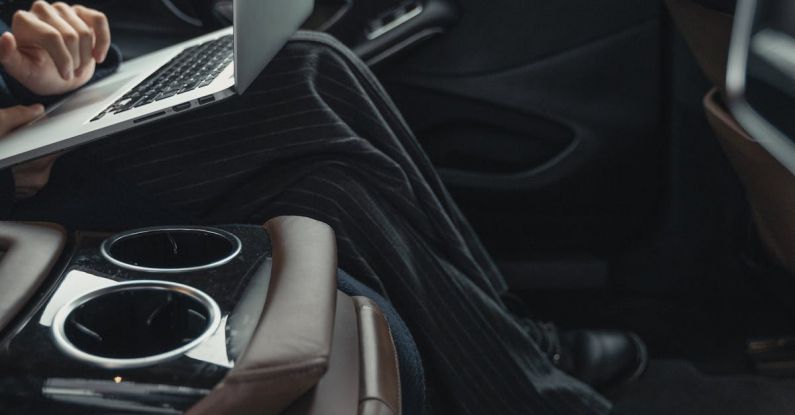 Inclusive Leader - Person Seated At The Back Seat Using Macbook