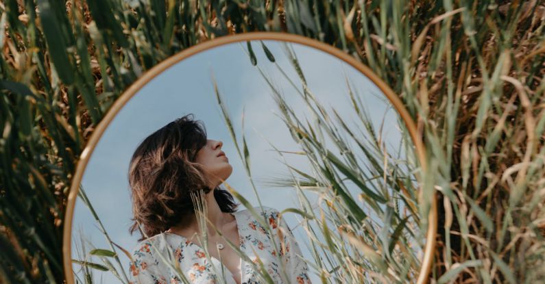 Creative Constraints - A woman in a field looking at a mirror