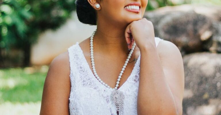 Lateral Thinking - A beautiful young woman in a white dress sitting on a rock