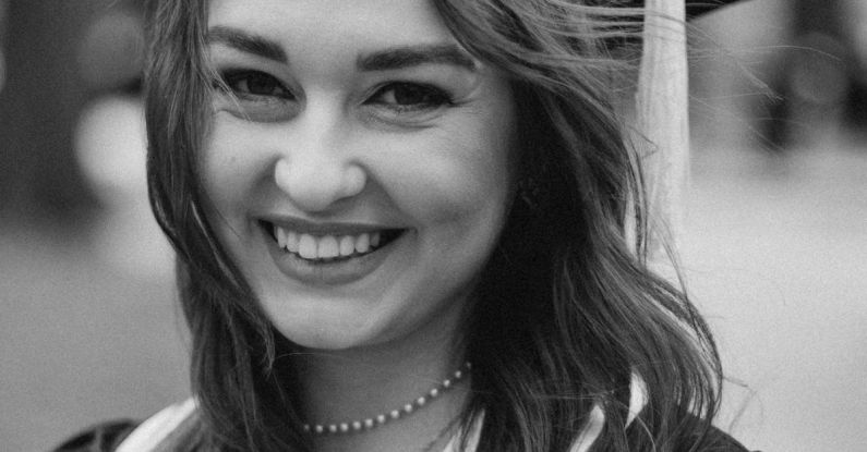 Bilingual Education - A black and white photo of a woman in a graduation gown