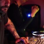 Gene Editing - A man with a beard and tattoos playing music