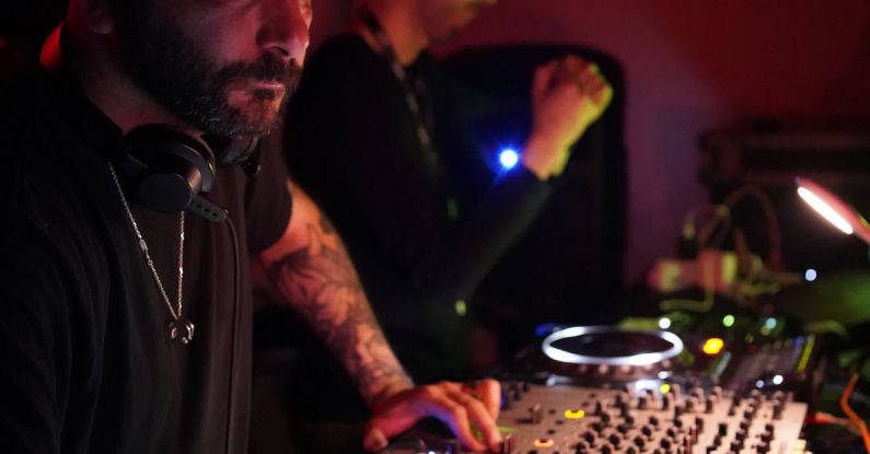 Gene Editing - A man with a beard and tattoos playing music